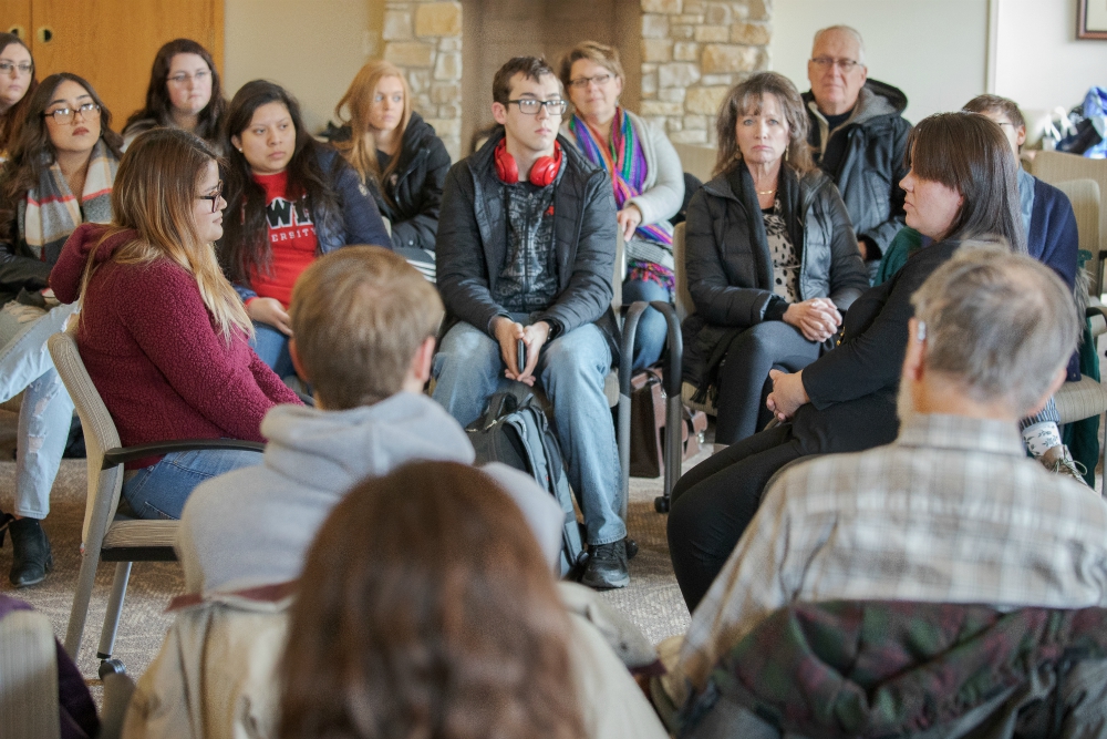 Heather Rivett, right, an actor in "The Visiting Room," sits facing an audience member during a performance March 4 at Lewis University in Romeoville, Illinois. (Joseph Glatz)