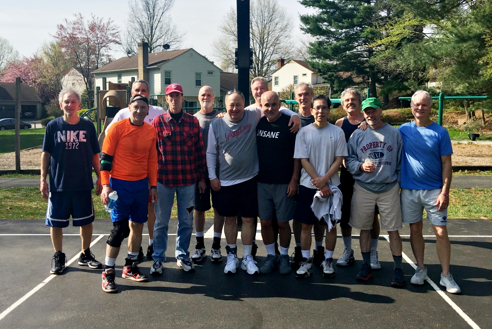 Jack McHale (center, black shirt) with friends at their weekly Sunday morning basketball games. McHale has recruited many of the men from these games to join on his trips into D.C. over the years. (Provided photo)