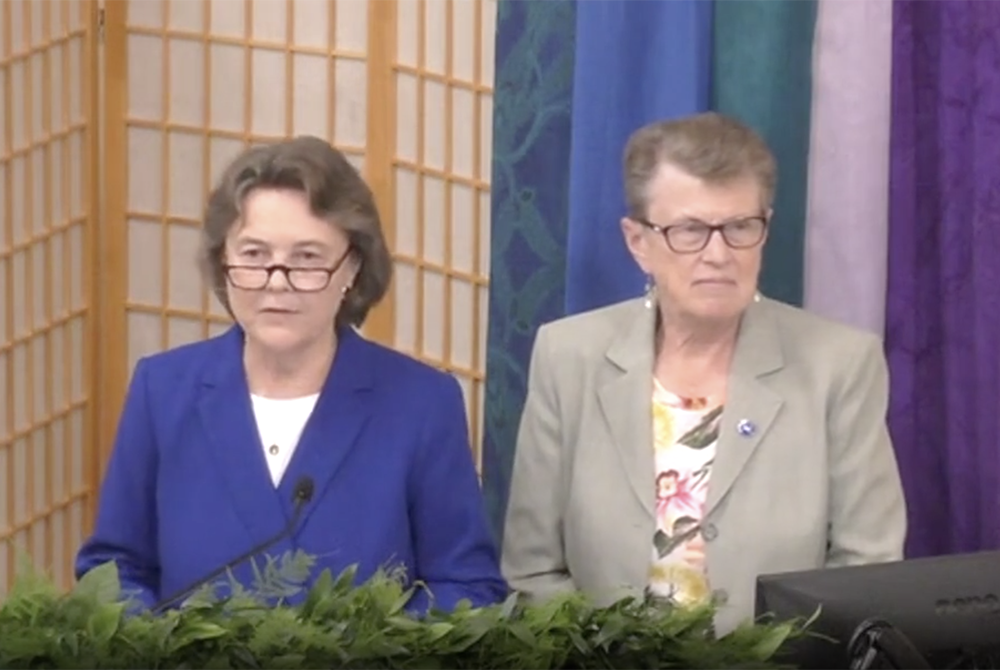 Immaculate Heart of Mary Sr. Jane Herb, right, the president-elect of the Leadership Conference of Women Religious, joins Dominican Sr. Elise García, LCWR president, to ask for forgiveness for racism in religious life at the end of García's presidential 