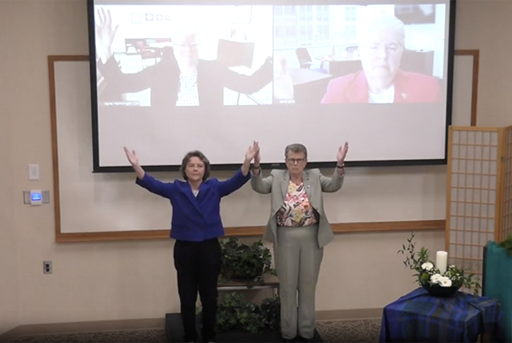 Clockwise from top left: Sr. Jayne Helmlinger, president of the Leadership Conference of Women Religious; Sr. Carol Zinn, LCWR executive director; Sr. Jane Herb, LCWR president-elect; and Sr. Elise García, LCWR president, join in prayer at the end of Garc