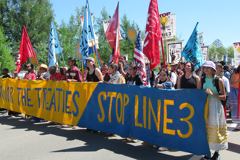 During a protest against the Enbridge Line 3 pipeline June 7, demonstrators march along a highway to call for treaty rights to be honored. (Claire Schaeffer-Duffy)