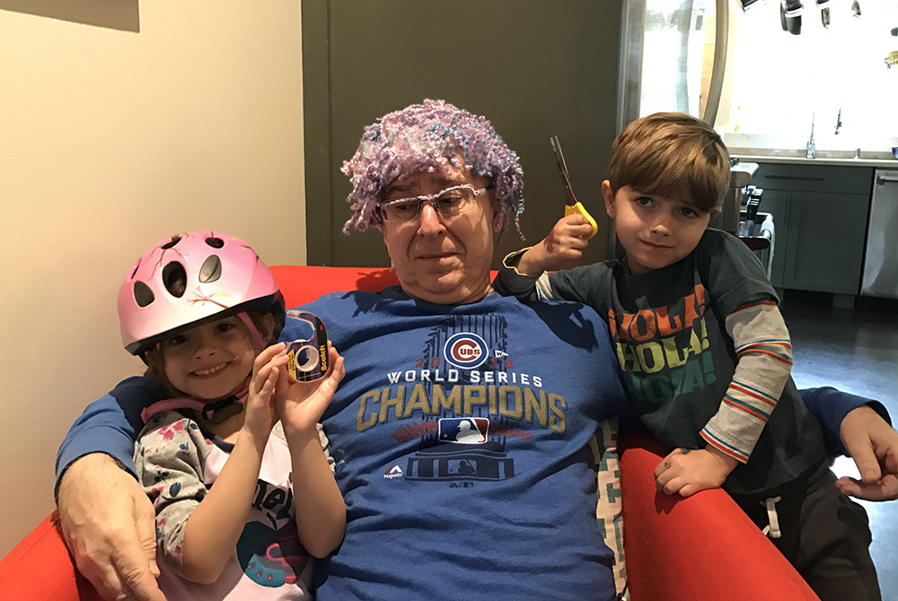 Grampa Michael Leach shows off the "hair transplant" created by his twin grandchildren, Mae and Jackson Leach. He wore it all the way back home on the plane from Atlanta to New York. (Courtesy of Jeff Leach)