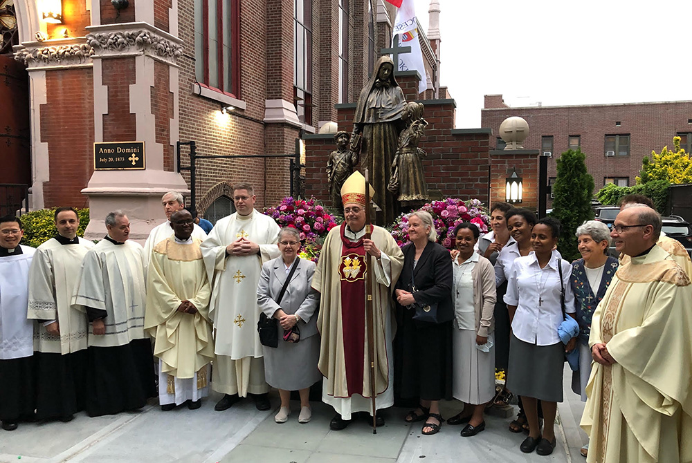 Bishop Nicholas DiMarzio stands with the members of the Missionary Sisters of the Sacred Heart of Jesus and others in attendance at the dedication of the new Mother Cabrini statue and shrine in the Carroll Gardens section of Brooklyn, New York. (Courtesy 