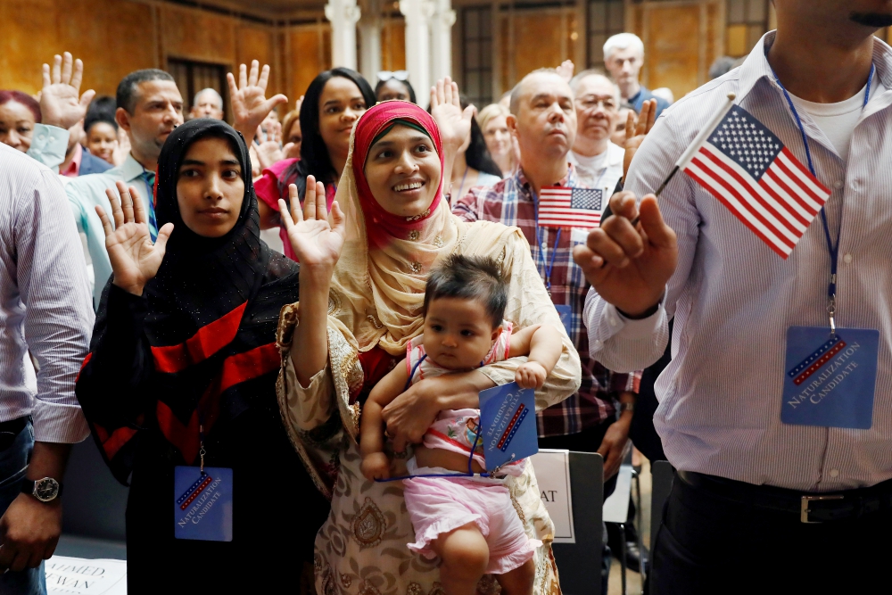 New citizens stand during the Pledge of Allegiance in July 2018 at the U.S. Citizenship and Immigration Services naturalization ceremony in the Manhattan section of New York City. (CNS/Reuters/Shannon Stapleton) New citizens stand during the Pledge of Allegiance in July 2018 at the U.S. Citizenship and Immigration Services naturalization ceremony in the Manhattan section of New York City. (CNS/Reuters/Shannon Stapleton)