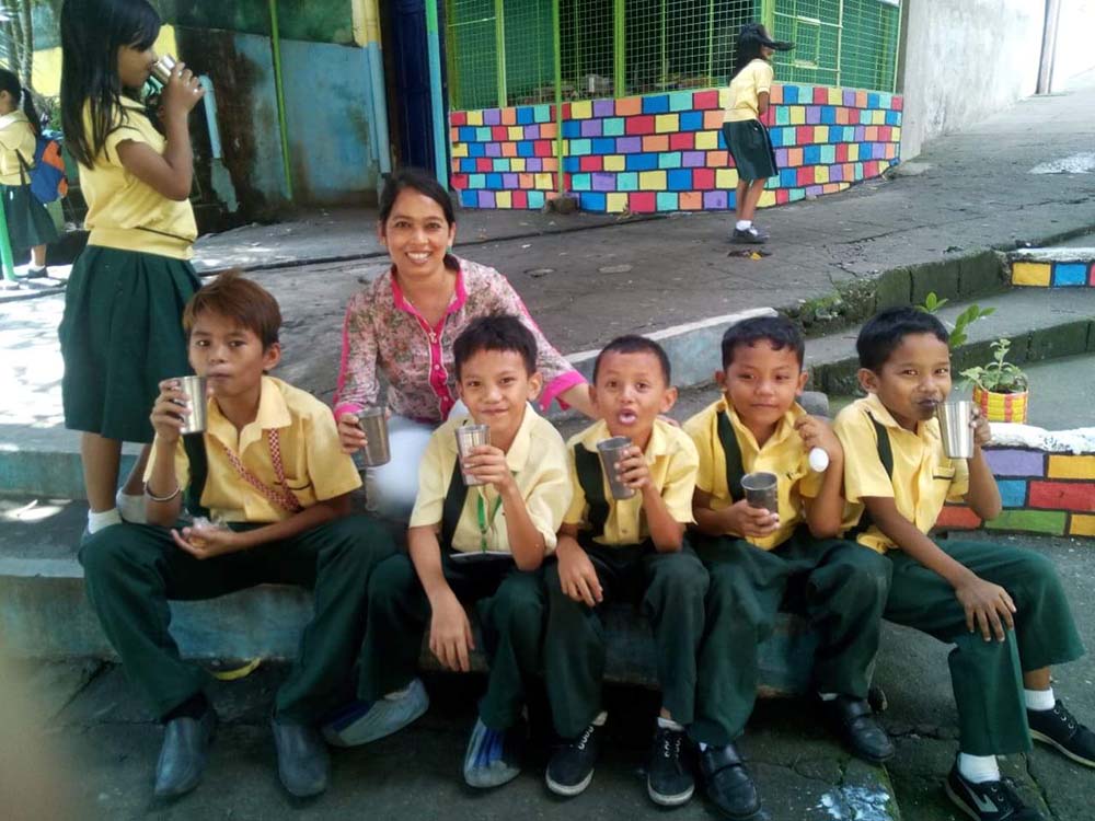 Sr. Sujata Jena in July 2019 with elementary children in the "Glass of Milk" program coordinated by the Sacred Heart Sisters, Bagong Silang, Philippines (Courtesy of Sujata Jena)