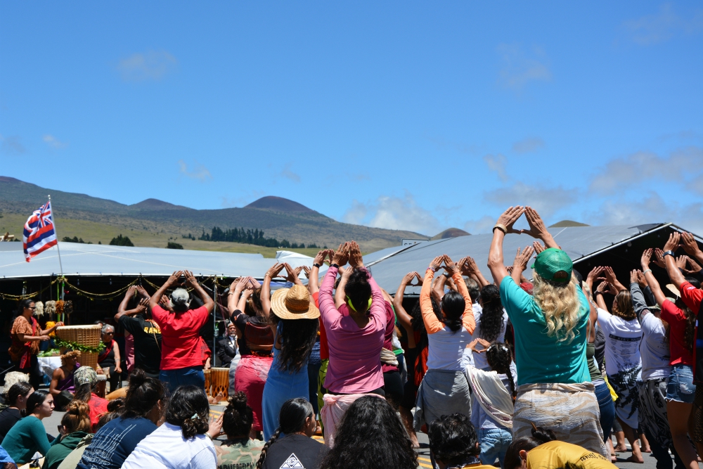 Protectors who oppose the construction of the Thirty Meter Telescope perform traditional Hawaiian dances at the base of Mauna Kea in Hawaii. (RNS/Jack Jenkins) Protectors who oppose the construction of the Thirty Meter Telescope perform traditional Hawaiian dances at the base of Mauna Kea in Hawaii. (RNS/Jack Jenkins)
