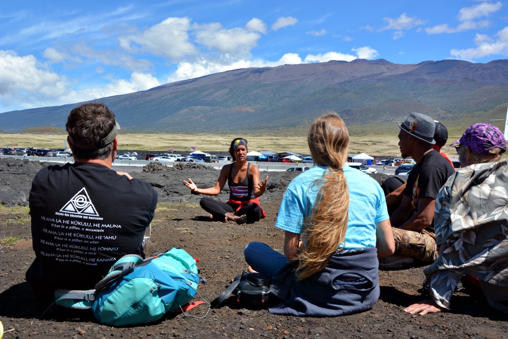 Mehana Makainai teaches a workshop on "land-based religion" in the protest camp at the base of Mauna Kea, Hawaii. (RNS/Jack Jenkins) Mehana Makainai teaches a workshop on "land-based religion" in the protest camp at the base of Mauna Kea, Hawaii. (RNS/Jack Jenkins)