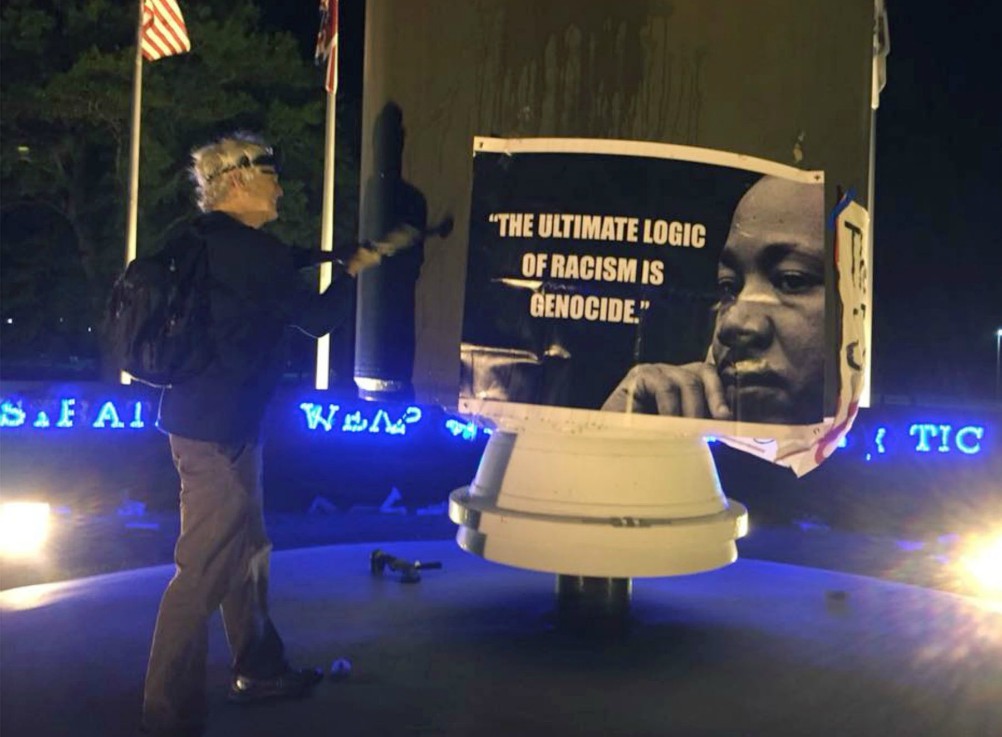 Patrick O’Neill attempts to deface a nuclear monument with a hammer at the Kings Bay Naval Submarine Base in April 2018. (RNS/Courtesy of the Kings Bay Plowshares 7)