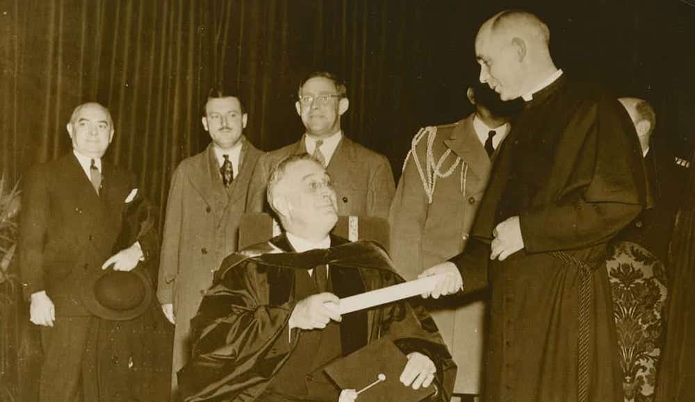 President Franklin D. Roosevelt, left, receives an honorary degree from University of Notre Dame President Holy Cross Fr. John F. O'Hara at a special convocation in December 1935. (Courtesy of University of Notre Dame Archives) President Franklin D. Roosevelt, left, receives an honorary degree from University of Notre Dame President Holy Cross Fr. John F. O'Hara at a special convocation in December 1935. (Courtesy of University of Notre Dame Archives)