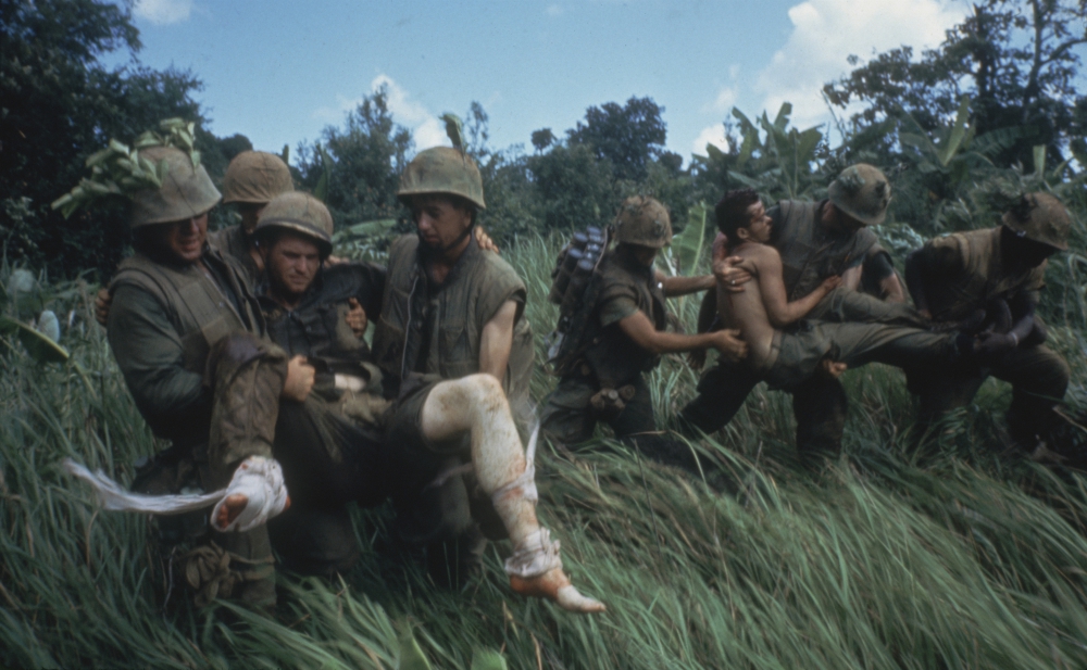 Marines carrying their wounded during firefight near the DMZ, 1966. (PBS/Courtesy of Getty Images/Larry Burrows)