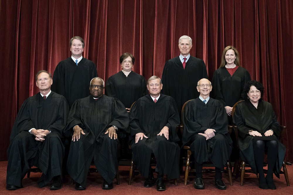 Members of the Supreme Court pose for a group photo at the Supreme Court in Washington, April 23, 2021.