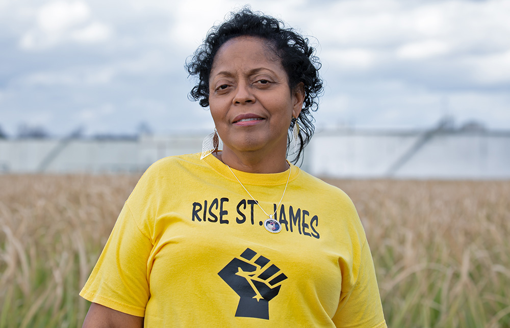 Sharon Lavigne, the 2021 Goldman Environmental Prize winner for North America, in front of oil storage tanks in St. James Parish, Louisiana (Courtesy of Goldman Environmental Prize)