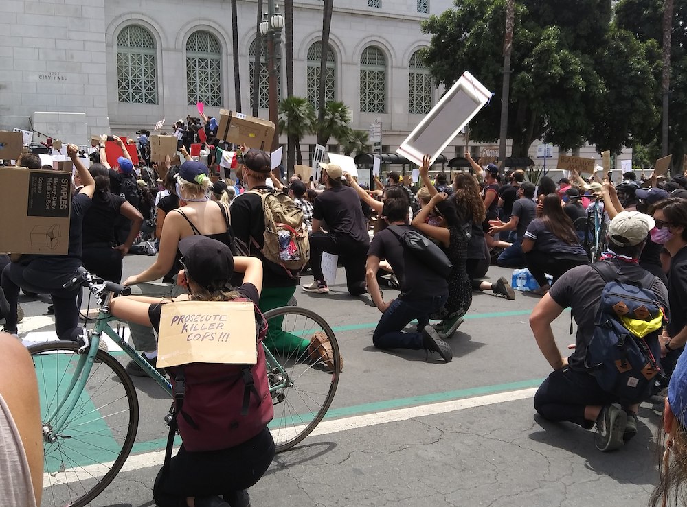 Demonstrators supporting George Floyd and protesting police brutality and killings, especially against Black people, take a knee at City Hall in Los Angeles, for "Blackout Tuesday," June 2 (Wikimedia Commons/Kriddl)