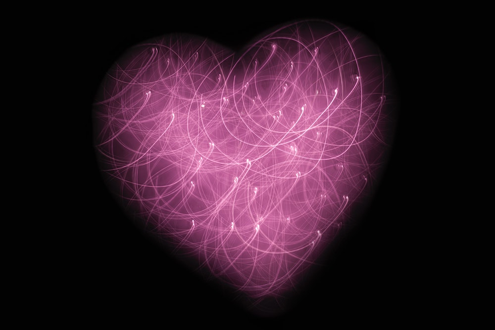 Heart image made of points of light (Unsplash/Jude Beck)