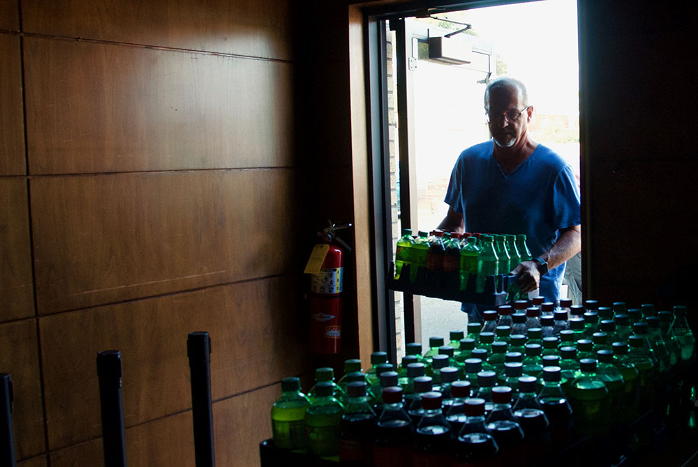 A volunteer carries donations into the food pantry at Ministry on the Margins in Bismarck, North Dakota. (GSR photo/Dan Stockman)