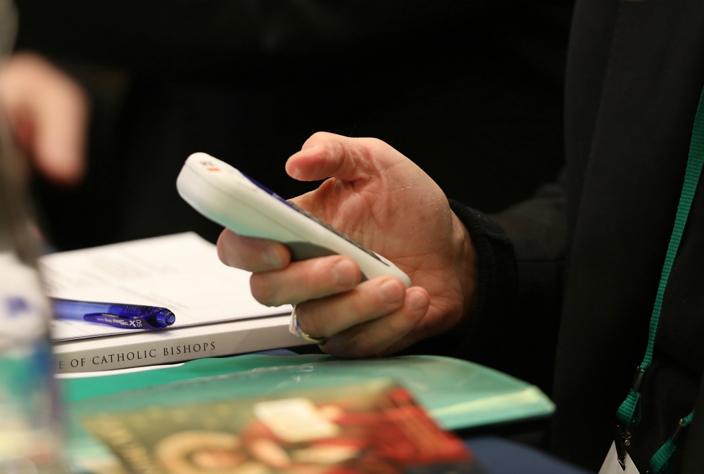 A bishop casts his vote during last year's fall general assembly of the U.S. Conference of Catholic Bishops in Baltimore Nov. 11, 2019. (CNS/Bob Roller)