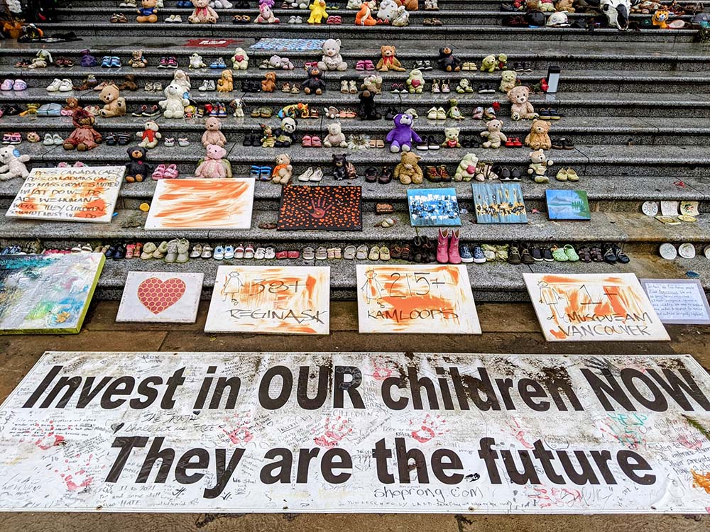 In front of steps of Vancouver Art Gallery, rows of children’s shoes and toys are seen Jan. 30 as a memorial to the 215 Indigenous children whose remains were found buried on unmarked side near the former Kamloops Indian Residential School.