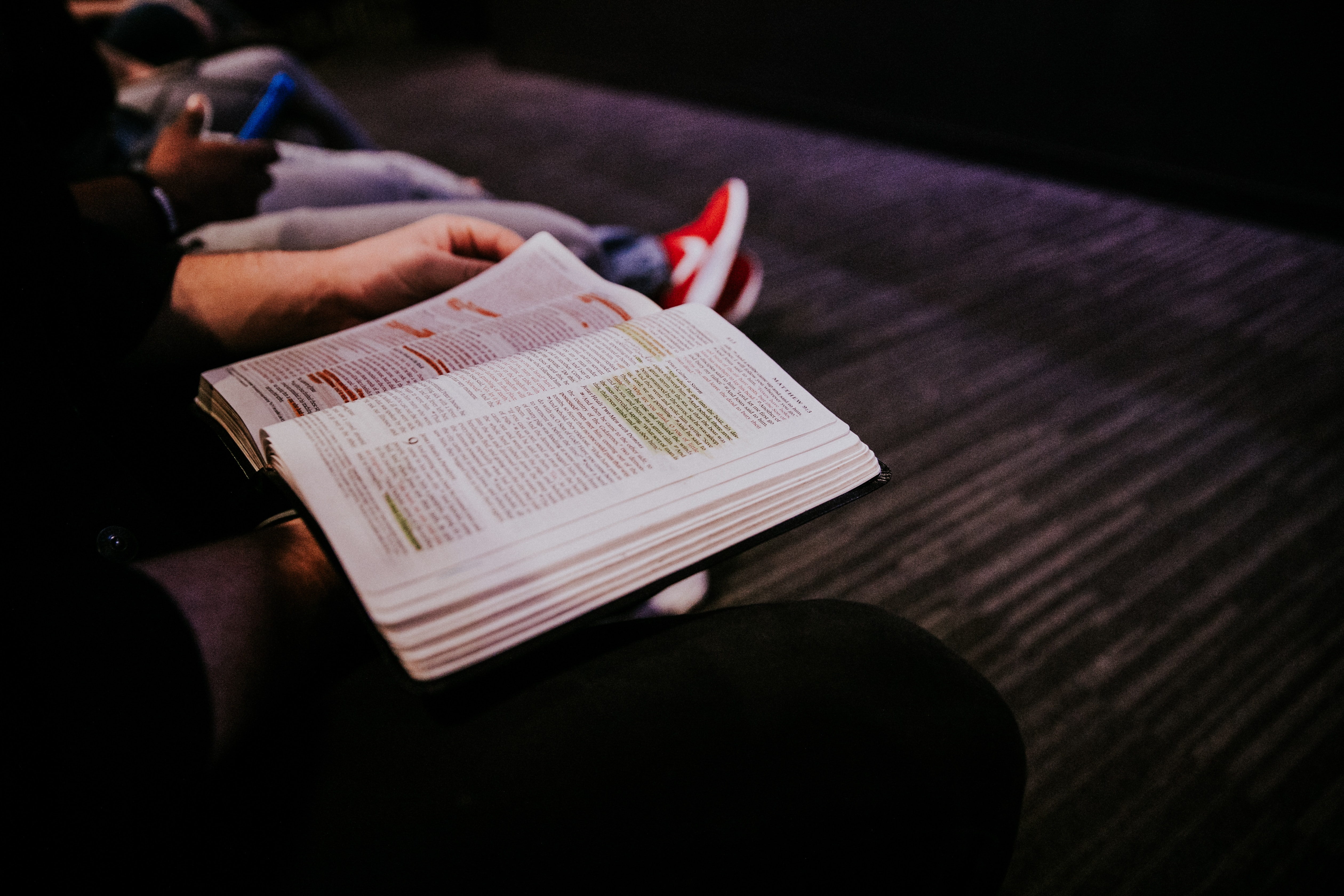 Woman reads a highlighted Bible