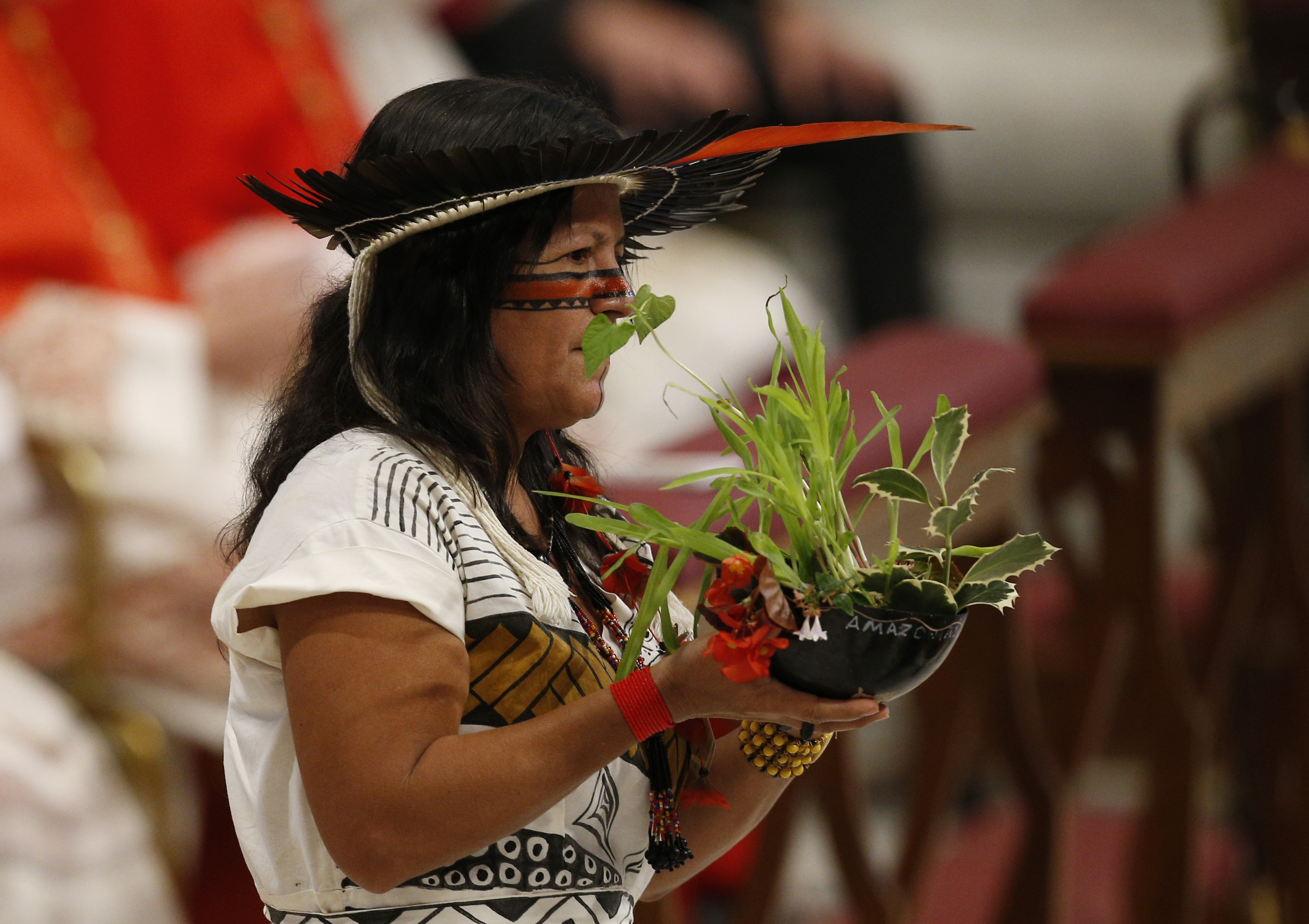 Marcivana Rodrigues Paiva, representing the Satere-Mawe indigenous people in Brazil, carries a plant in the offertory procession as Pope Francis celebrates the concluding Mass of the Synod of Bishops for the Amazon at the Vatican Oct. 27, 2019. (CNS photo Marcivana Rodrigues Paiva, representing the Satere-Mawe indigenous people in Brazil, carries a plant in the offertory procession as Pope Francis celebrates the concluding Mass of the Synod of Bishops for the Amazon at the Vatican Oct. 27, 2019. (CNS photo