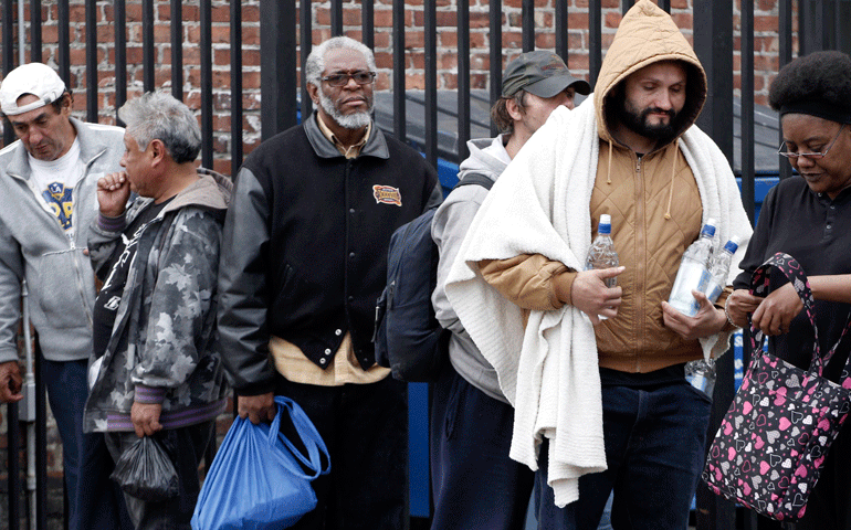People wait in line for an early Thanksgiving meal served to the homeless and others at the Los Angeles Mission in Los Angeles Nov. 27. (CNS/Reuters/Jonathan Alcorn)