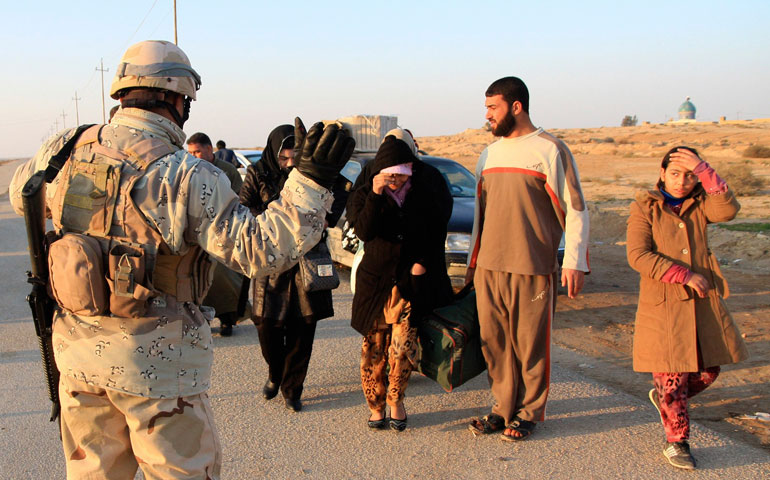 A member of Iraqi security forces stands guard at a checkpoint in Ein Tamarm, a town some 25 miles west of Karbala, Jan 6. (Reuters/Mushtaq Muhammed)