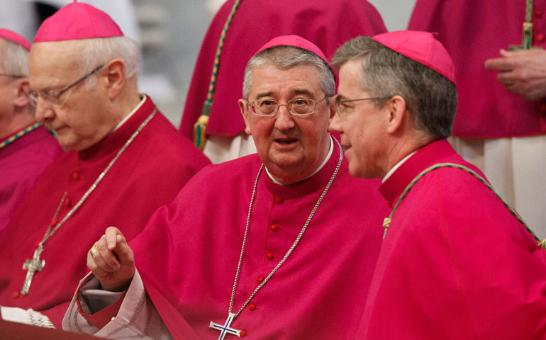 Archbishop Diarmuid Martin of Dublin, center, talks with Archbishop Charles Brown, apostolic nuncio to Ireland, right, at the Vatican Jan. 6 (CNS/Paul Haring)