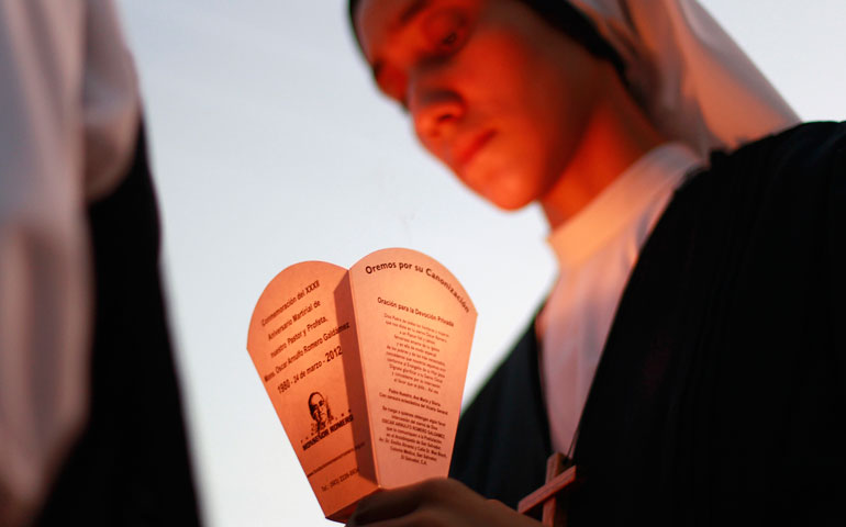 A nun holds a candle as she takes part in a march prior to the 33rd anniversary of the murder of Archbishop Oscar Romero in San Salvador, El Salvador, March 16. (CNS/Reuters/Ulises Rodriguez)