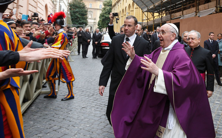 Pope Francis greets people after celebrating Mass at St. Anne’s Parish within the Vatican March 17. The new pope greeted every person leaving the small church and then walked over to meet people waiting around St. Anne’s Gate. (CNS/Paul Haring)