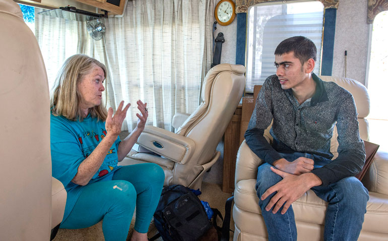 Peggy Herman speaks with Indian asylum seeker Jaskarn Singh, 21, at the Post-Detention Welcome Center July 16. (AP/Dean J. Koepfler/The News Tribune)