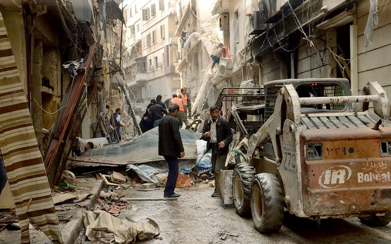 Syrian citizens clear streets in late April after shelling in Aleppo. (CNS/Reuters/Syrian Arab News Agency)