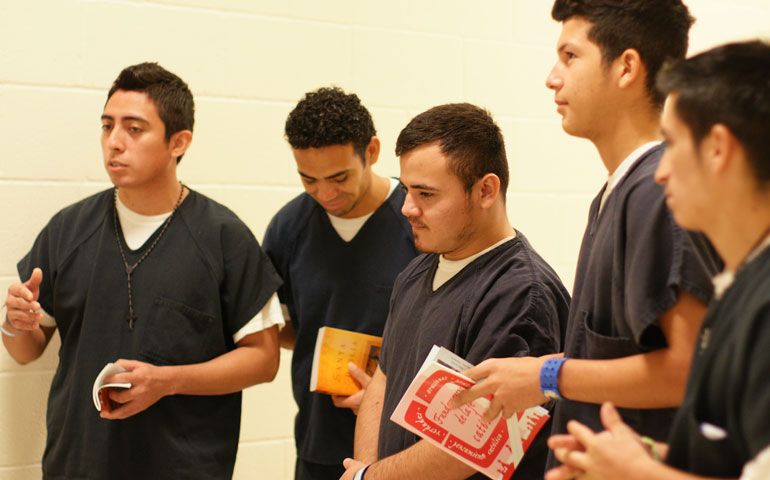 Five Catholic detainees held at the Northwest Detention Center in September listen to pastoral minister Esmeralda Saltos (not pictured) following a Sunday worship service that Saltos helped organize and lead. (Maria Laughlin)