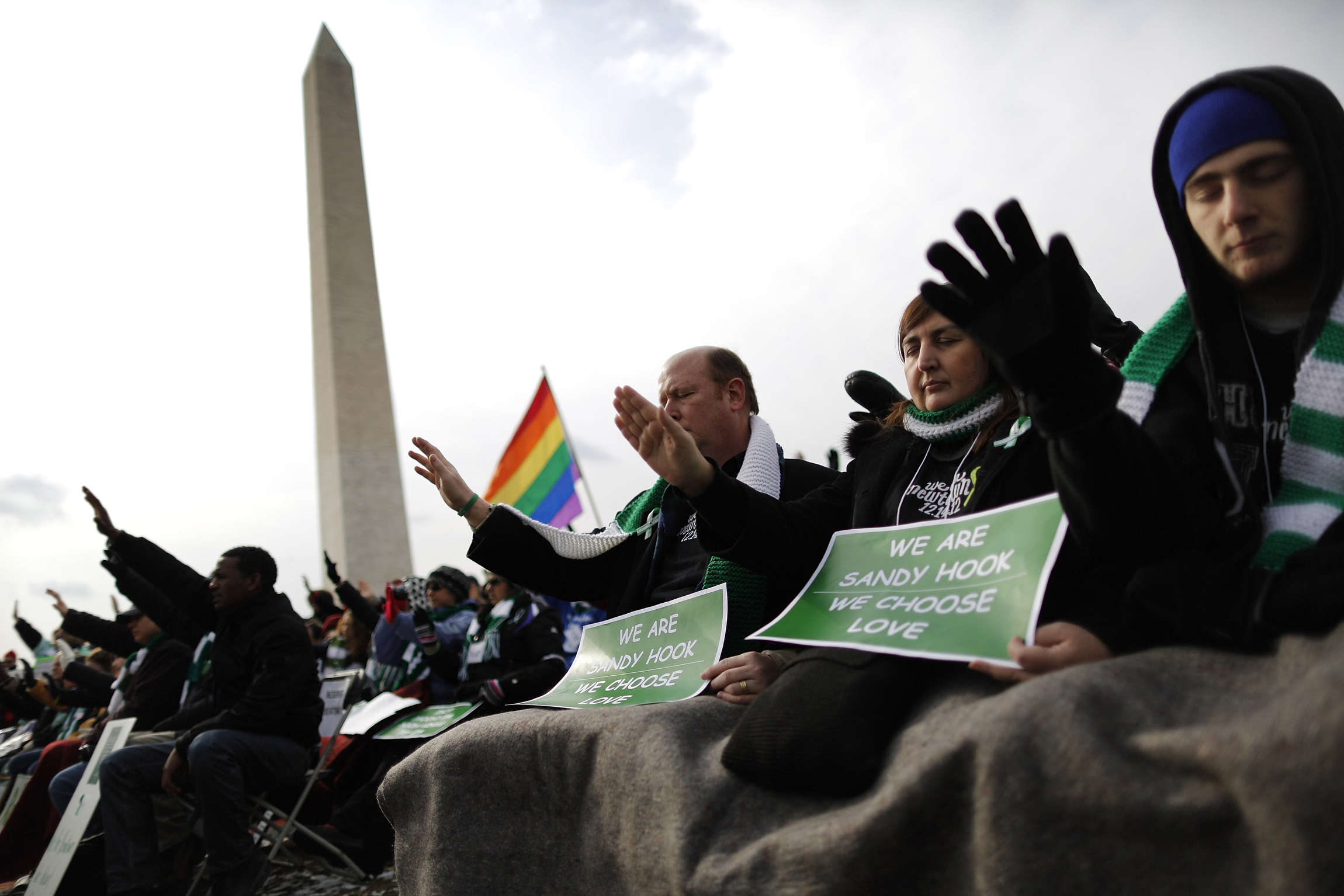 People hold their hands outstretched toward the U.S. Capitol as they pray for government action against gun violence during the March on Washington for Gun Control on the National Mall in Washington Jan. 26. Thousands of people joined the rally for gun c ontrol, marching from the Capitol to the Washington Monument. (CNS photo/Jonathan Ernst, Reuters)