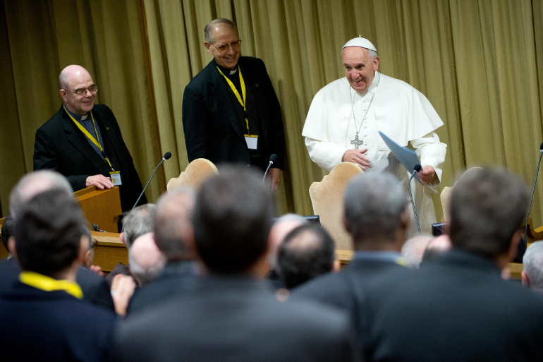 Pope Francis arrives for a meeting with 120 superiors of men's religious orders at the Vatican Nov. 29, 2013. Standing next to the pope is Fr. Adolfo Nicolas, superior general of the Society of Jesus. (CNS/L'Osservatore Romano)