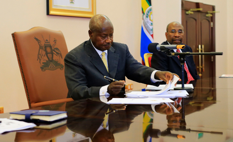 Uganda President Yoweri Museveni signs an anti-homosexuality bill into law in Entebbe Feb. 24. (CNS/Reuters/James Akena)