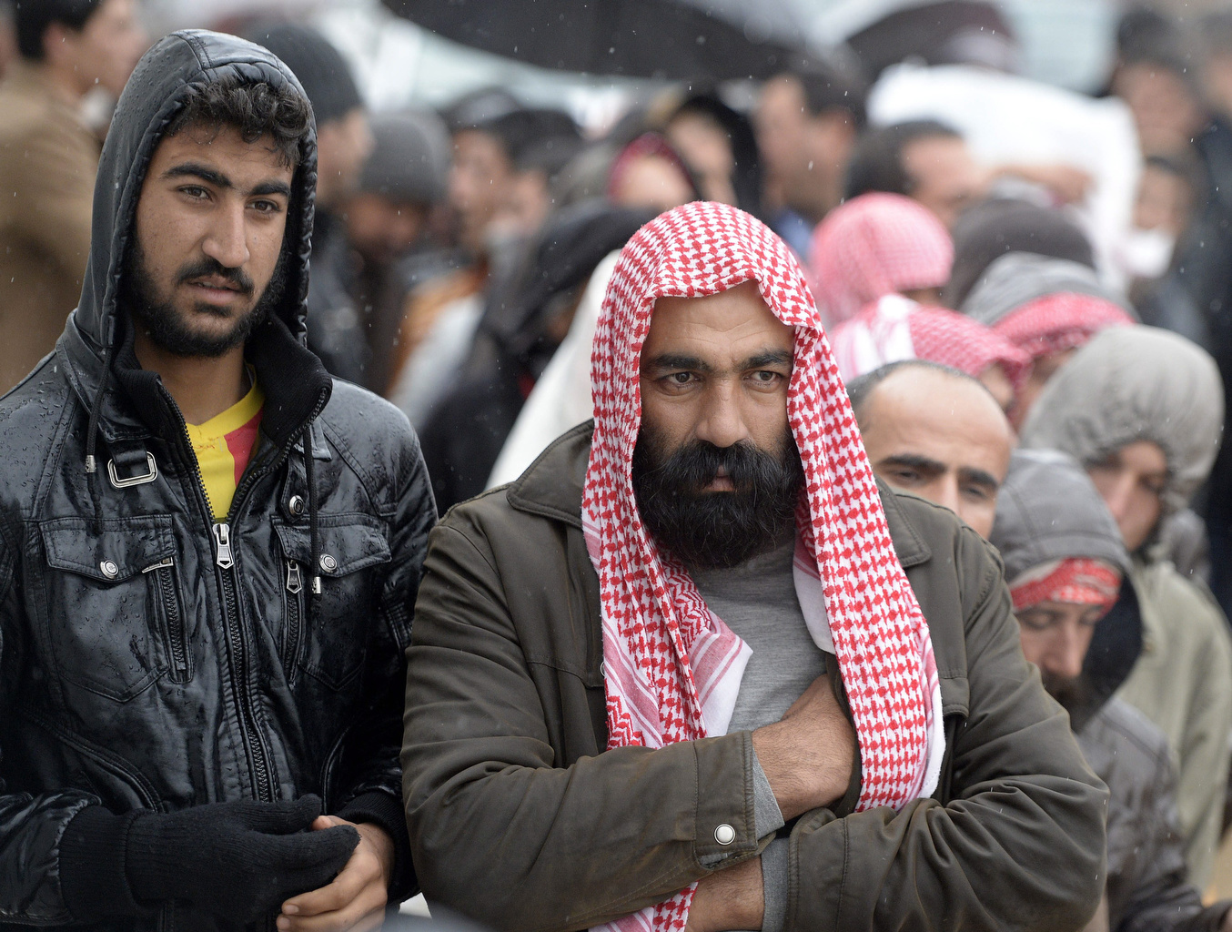 Iraqis forced to flee from advancing Islamic State militants wait in line for humanitarian aid Dec. 10 at a camp for displaced people in Zakho, Iraq. (CNS/EPA/Darek Delmanowicz)