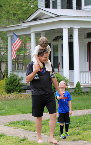 A father walks with his children May 3 along a sidewalk in Richmond, Va. Father's Day is celebrated Sunday, June 21 this year. (CNS/Jay Paul)