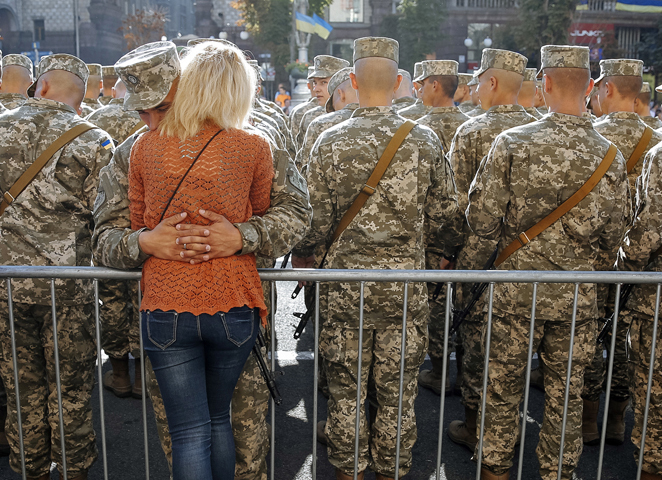 A Ukrainian serviceman hugs his girlfriend at Kiev's Independence Square Aug. 24. Ukrainians marked the 24th anniversary of Ukraine's independence from the Soviet Union. (CNS/Roman Pilipey, EPA)
