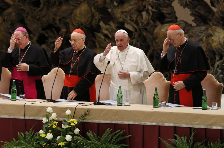 Pope Francis delivers his blessing during an event marking the 50th anniversary of the Synod of Bishops in Paul VI hall at the Vatican Oct. 17. The pope outlined his vision for how the entire church must be "synodal" with everyone listening to each other, learning from each other and taking responsibility for proclaiming the Gospel. (CNS/Paul Haring)