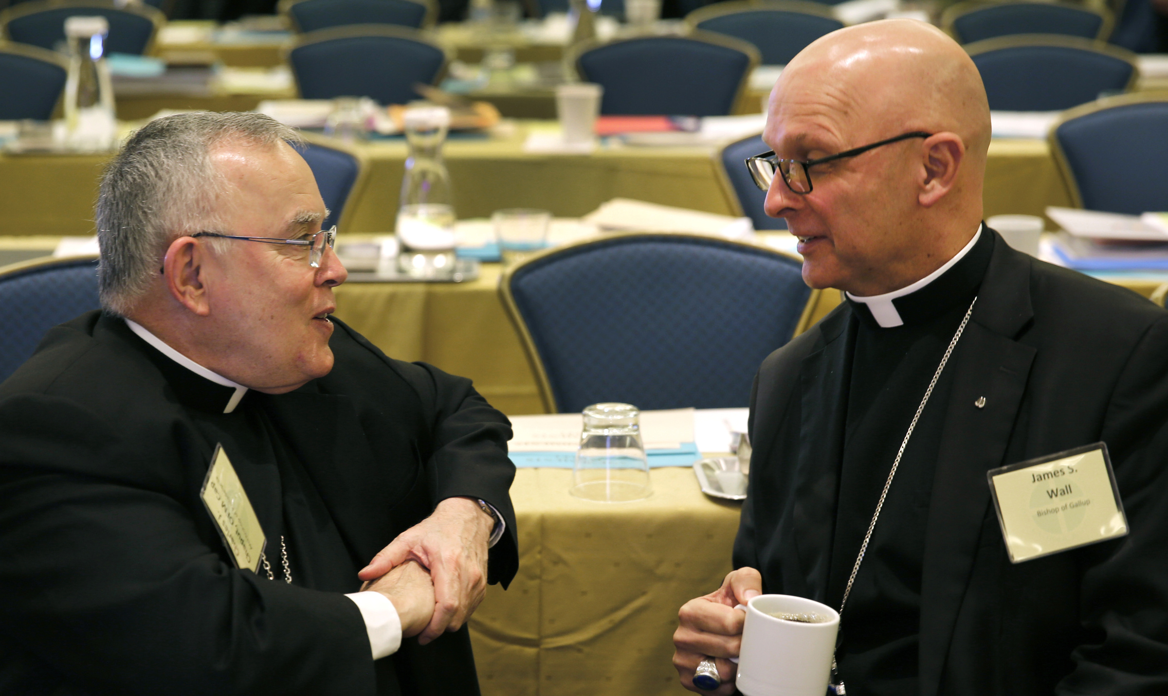 Archbishop Charles J. Chaput of Philadelphia and Bishop James S. Wall of Gallup, N.M., chat during a break at the 2015 fall general assembly of the U.S. Conference of Catholic Bishops in Baltimore Nov. 17. (CNS/Bob Roller)