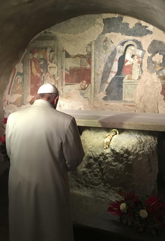 Pope Francis prays in front of a Nativity scene during surprise visit to the Franciscan shrine in Greccio, Italy. (CNS/L'Osservatore Romano, handout via EPA)