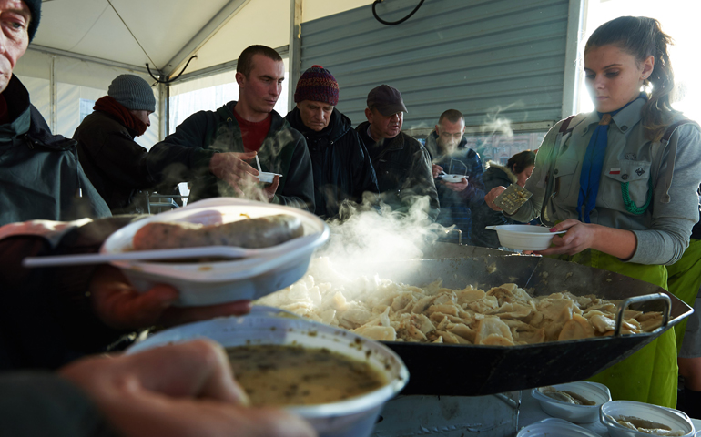 Homeless and the needy receive free meals on Christmas Eve in Gdansk, Poland. (CNS/Adam Warzawa, EPA)