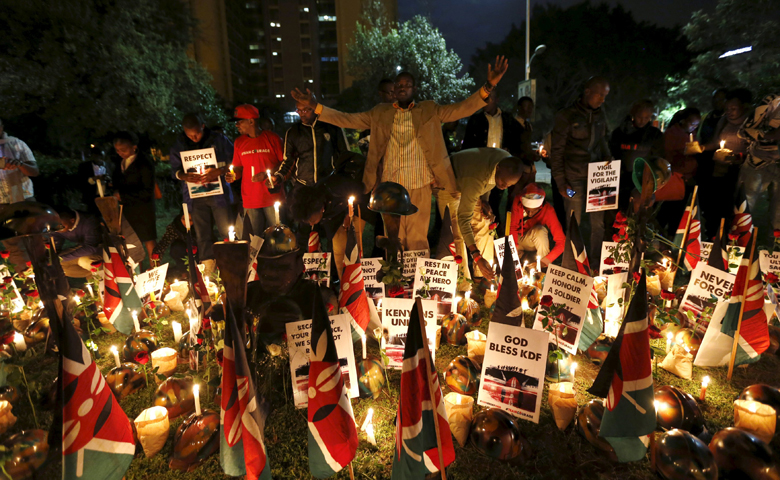 A man prays with others during a candlelight vigil in Nairobi, Kenya, Jan. 21 for soldiers killed while serving in the African Union Mission in Somalia. (CNS/Thomas Mukoya, Reuters)