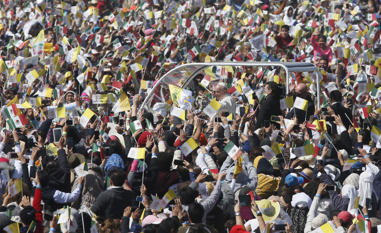 Pope Francis greets the crowd as he arrives to celebrate Mass in Ecatepec near Mexico City Feb. 14. (CNS photo/Paul Haring)