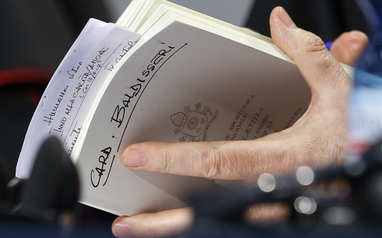 Cardinal Lorenzo Baldisseri, general secretary of the Synod of Bishops, holds his copy of Amoris Laetitia at the Vatican April 8. (CNS/Paul Haring)