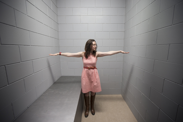 The Rev. Laura Markle Downton, director of the U.S. Prisons Policy and Program at the National Religious Campaign Against Torture, is pictured in a replica solitary confinement cell during the Ecumenical Advocacy Days event in 2015. (CNS/Erin Schaff, Perisphere Media)