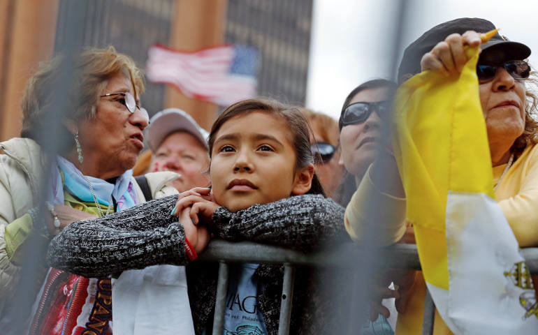 People watch on large screens as Pope Francis celebrates Mass in Philadelphia Sept. 26. World Youth Day organizers say the changing demographics of the church in the United States will be reflected in the pilgrims to World Youth Day in Krakow. (CNS photo/Jonathan Ernst, Reuters) 