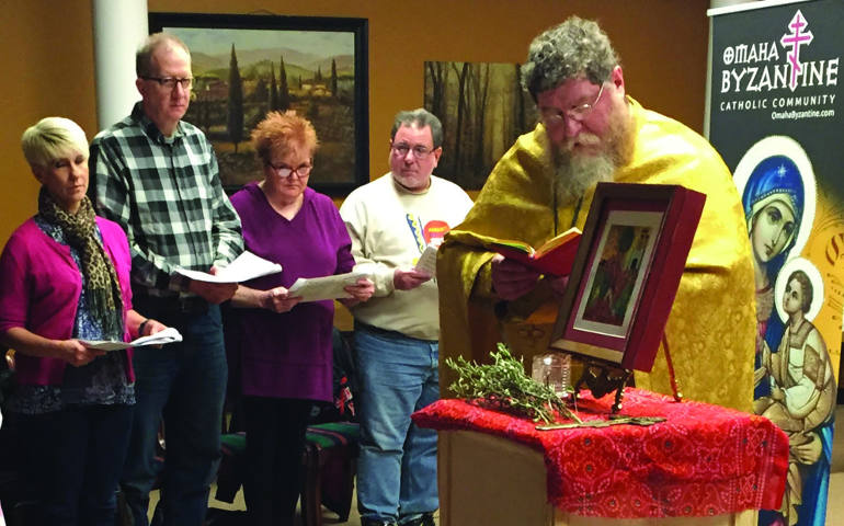 Benedictine Father Daniel Lenz leads a prayer for the newly inaugurated Omaha Byzantine Catholic Community in Omaha, Neb., June 26. Father Lenz is biritual, meaning he was ordained for the Latin rite but is permitted to celebrate Byzantine liturgies as well. (CNS photo/courtesy Omaha Byzantine Catholic Community)