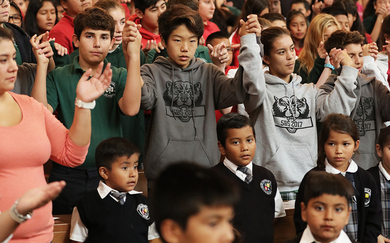 Young people join hands Oct. 25 during a children's Mass celebrated by Archbishop Jose H. Gomez at the Cathedral of Our Lady of the Angels in Los Angeles. (CNS/Victor Aleman, Vida Nueva)