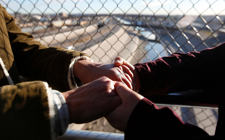 Women of the Boundless Across Borders organization hold hands during a Jan. 20 binational protest at the Santa Fe international crossing bridge in Ciudad Juarez, Mexico. (CNS/Jose Luis Gonzalez, Reuters)