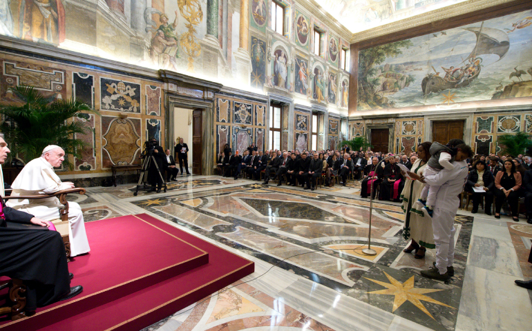 Refugees from Eritrea tell Pope Francis about their journey to safety during a meeting Feb. 21 at the Vatican with participants in the VI International Forum on Migration and Peace. (CNS photo/L’Osservatore Romano)